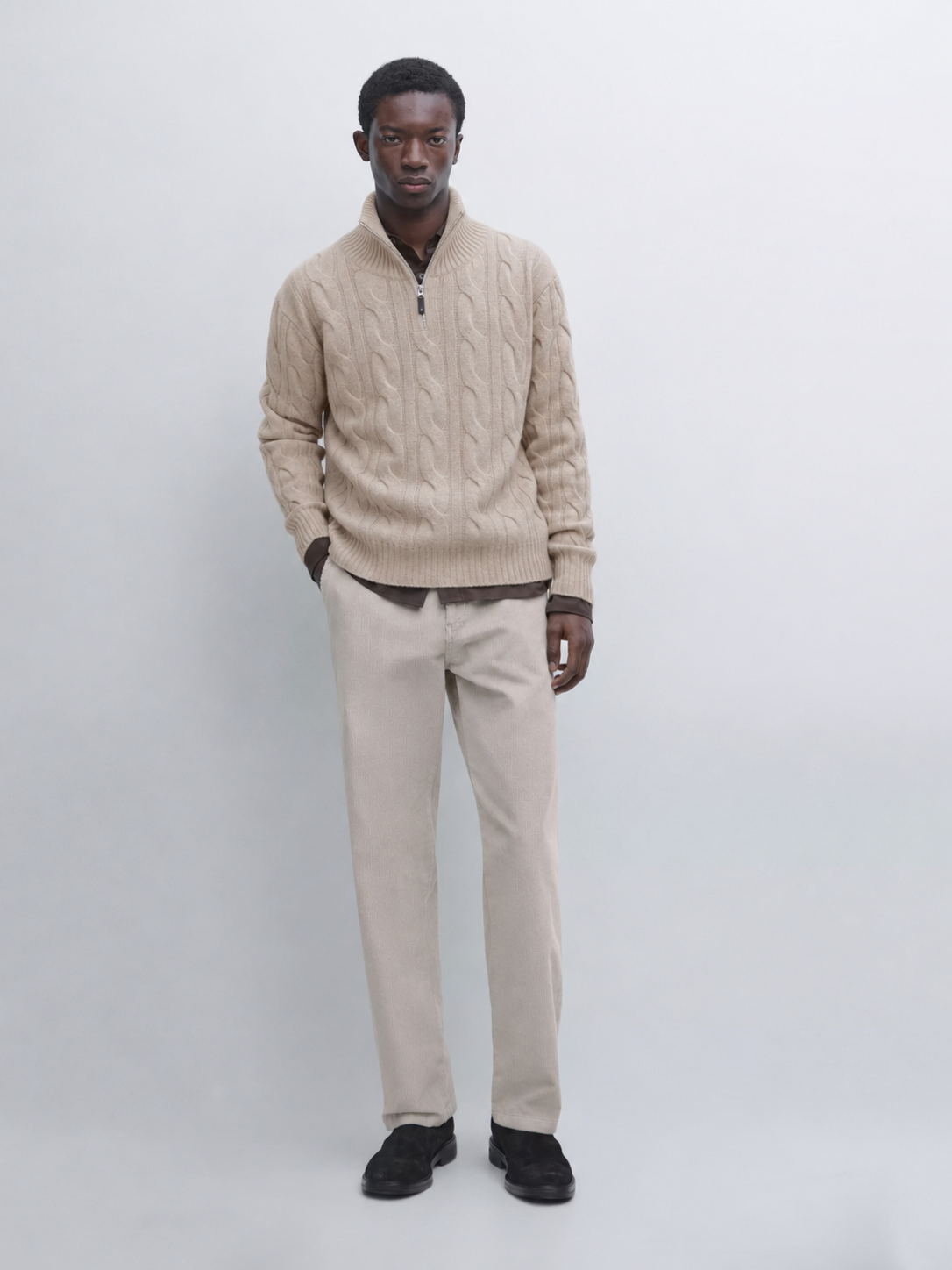 Model wearing the MELO Alden beige cable-knit half-zip sweater